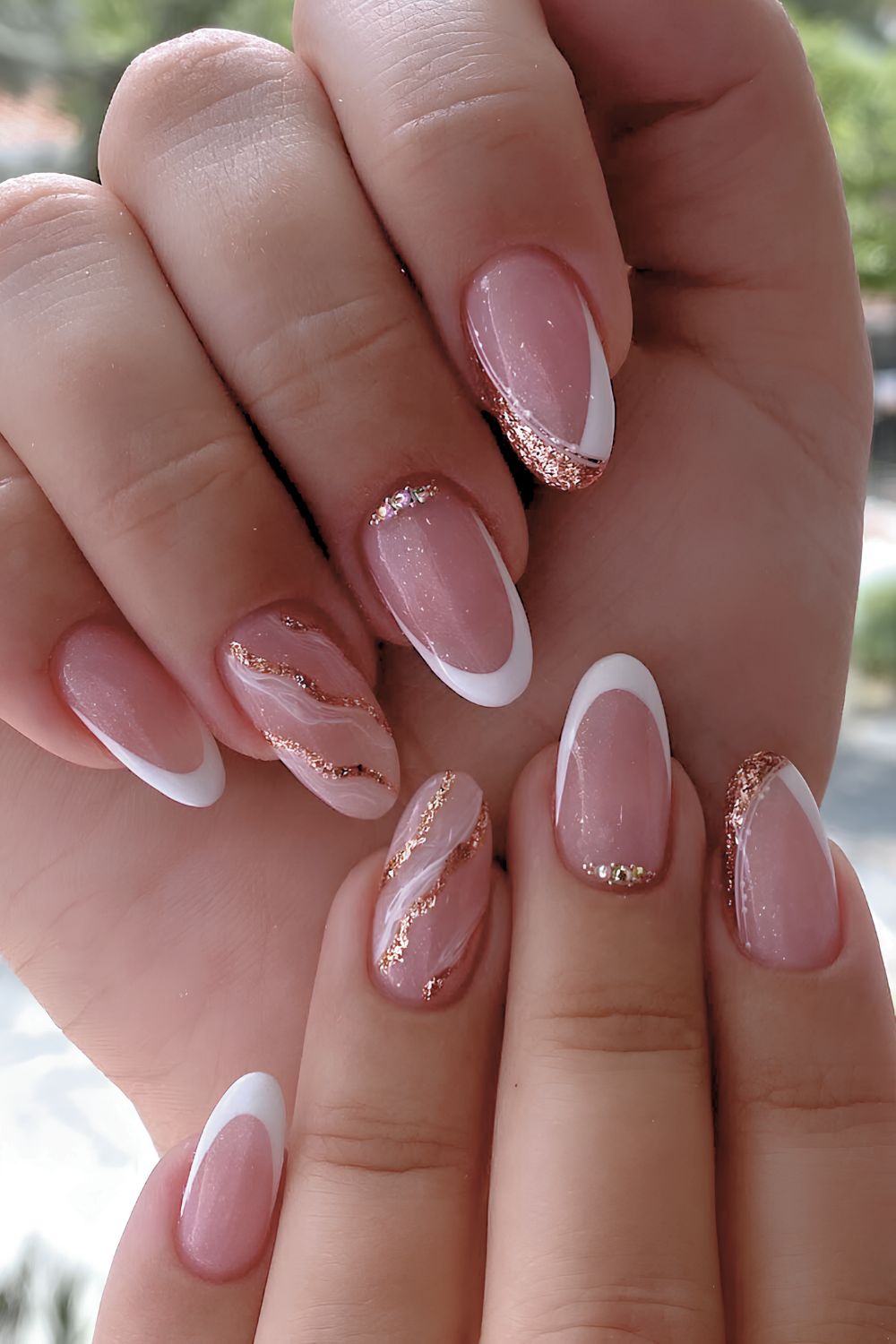 White French nails with gold glitter and marble accents