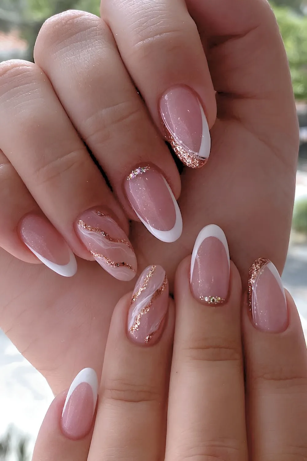 White French nails with gold glitter and marble accents