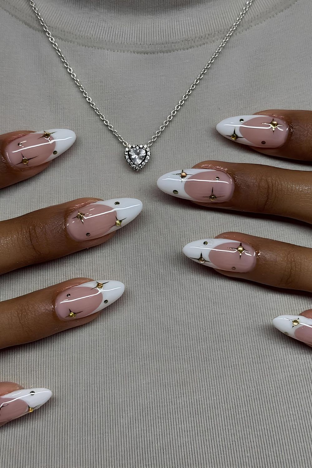 White French nails with gold stars and gems