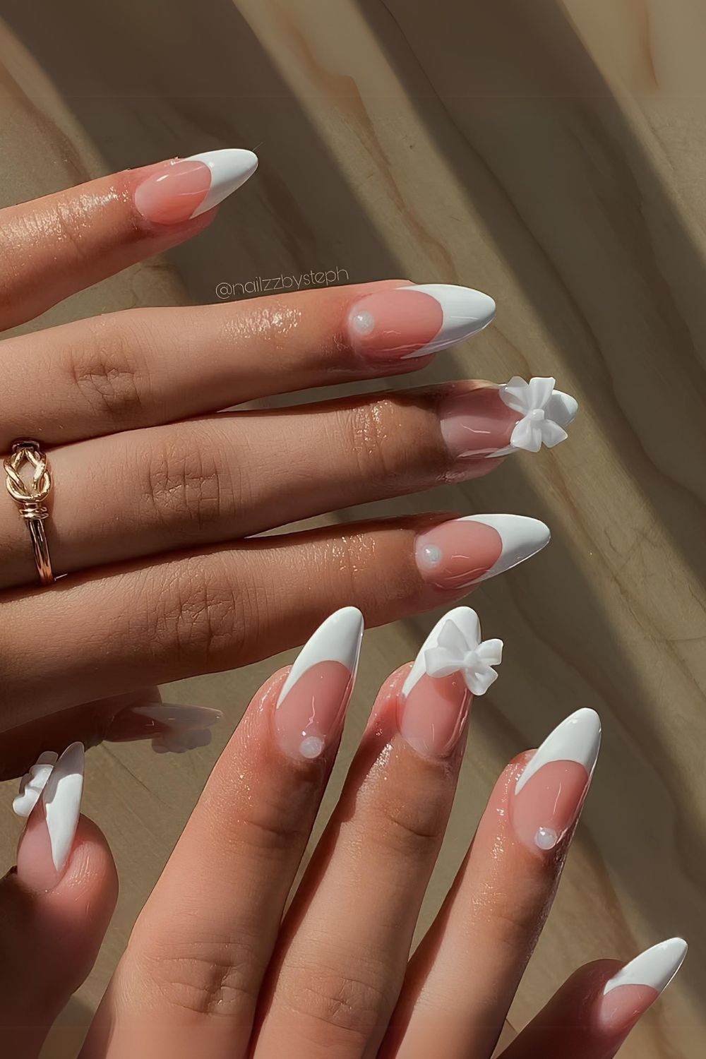 White French nails with pearls and 3D bows