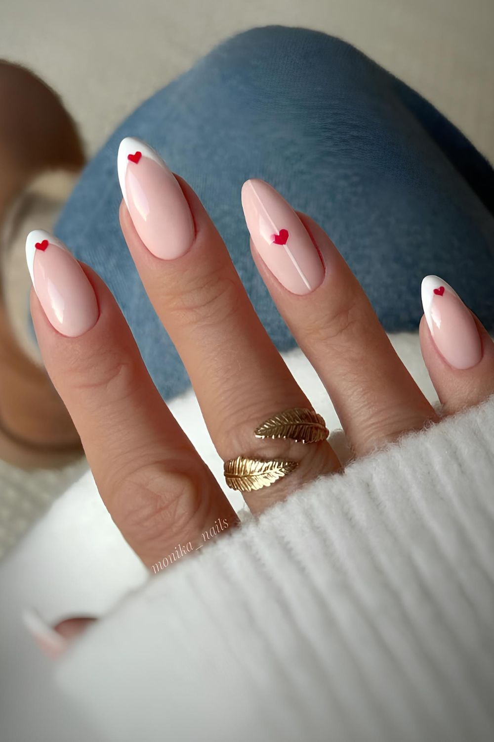 White French nails with red heart accents