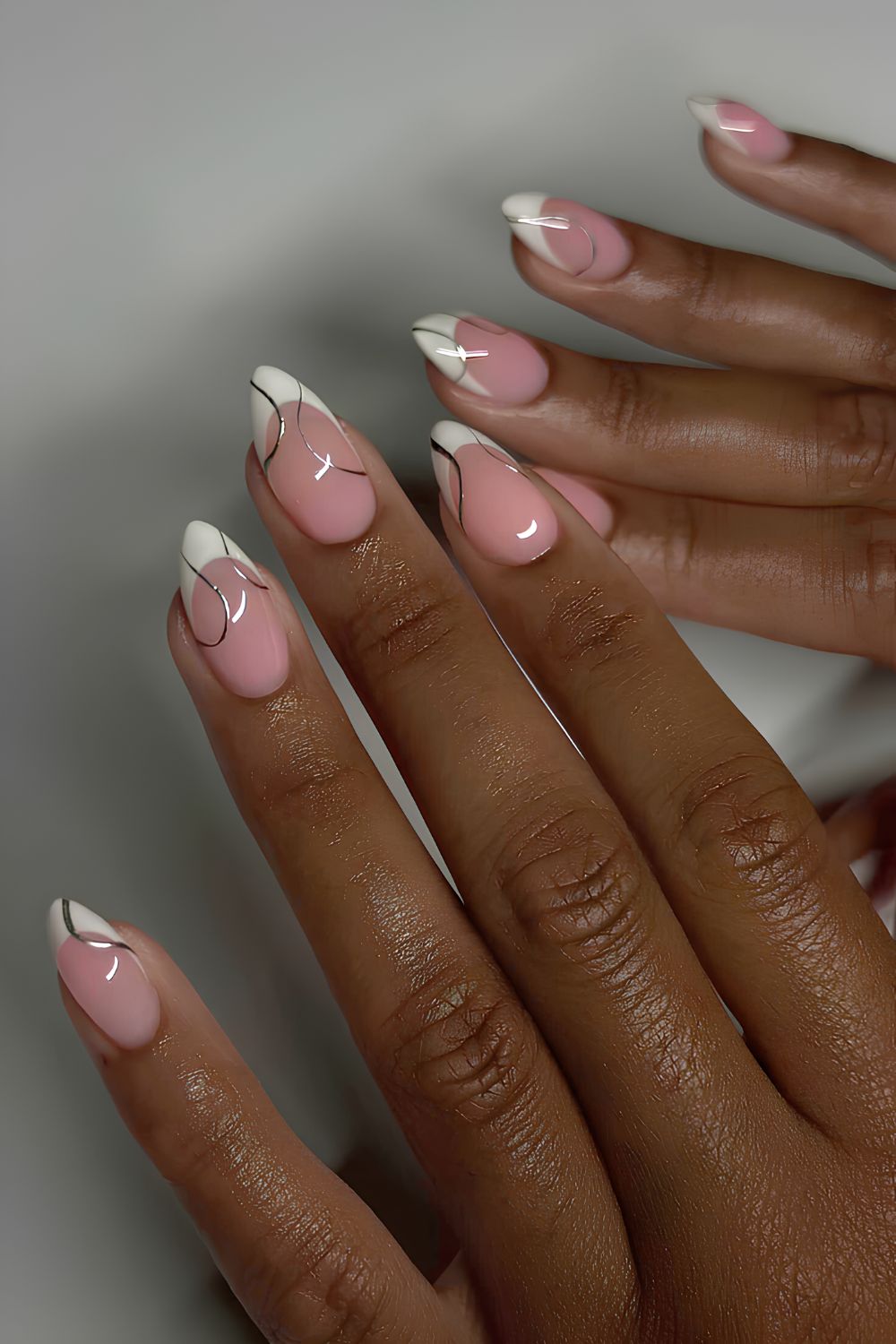 White French nails with silver swirls