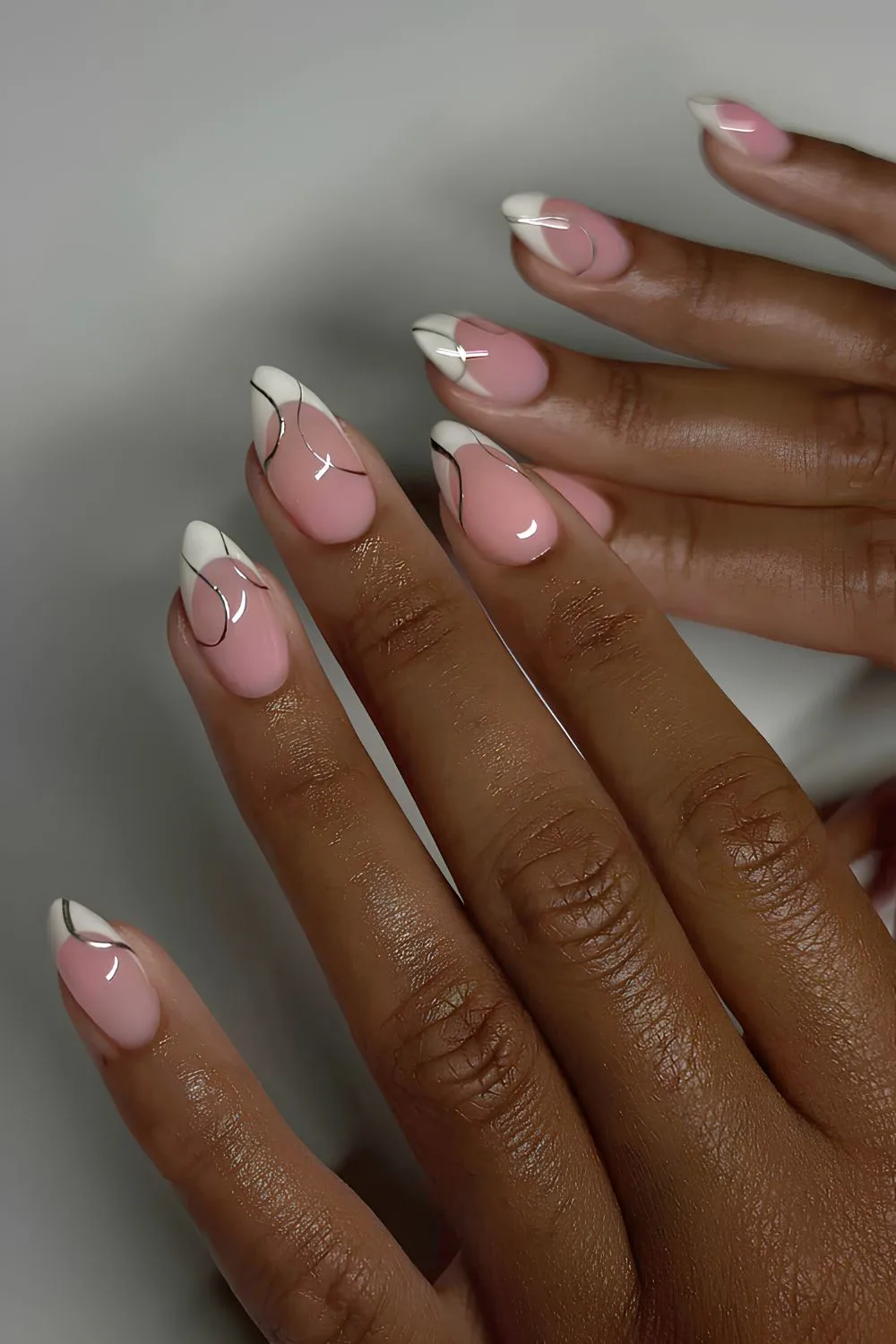 White French nails with silver swirls