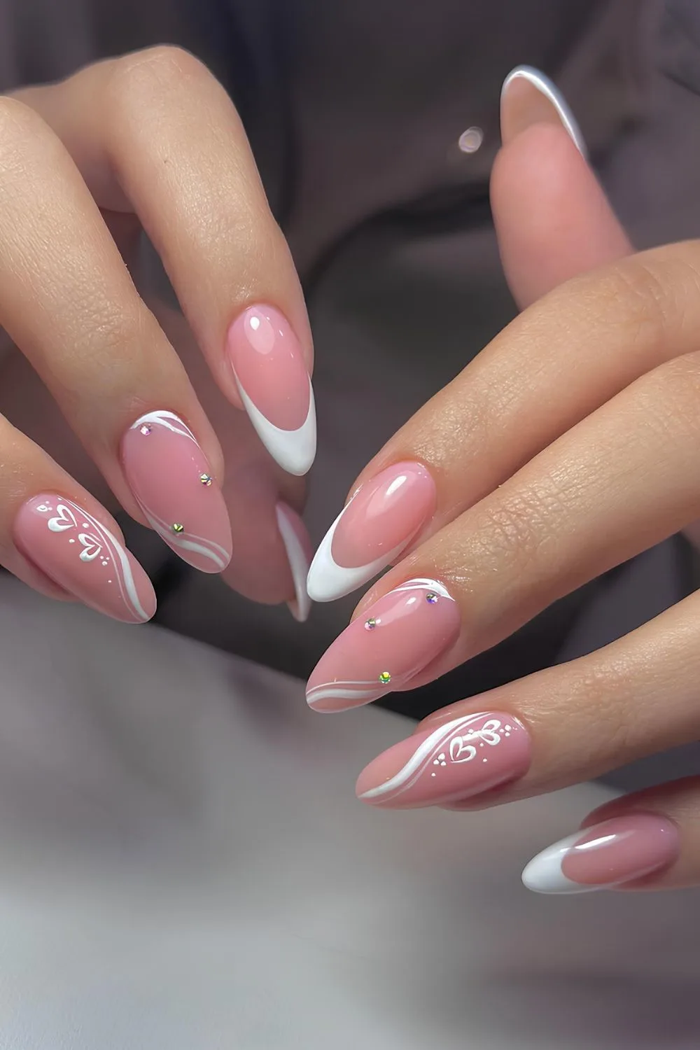 White French tip mani with swirls and hearts