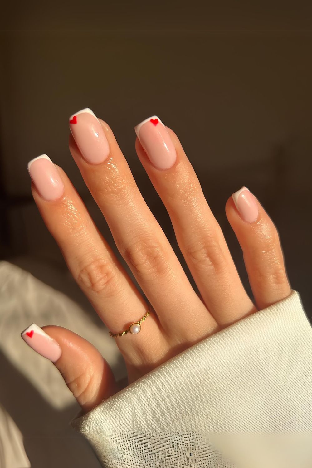 White French tips with red heart accents