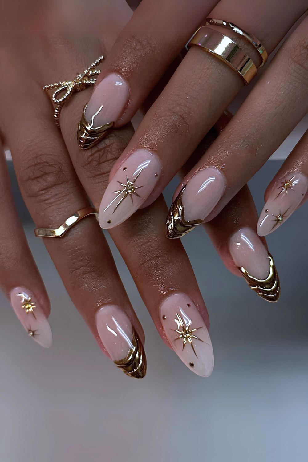 White mani with gold chrome drip and starbursts