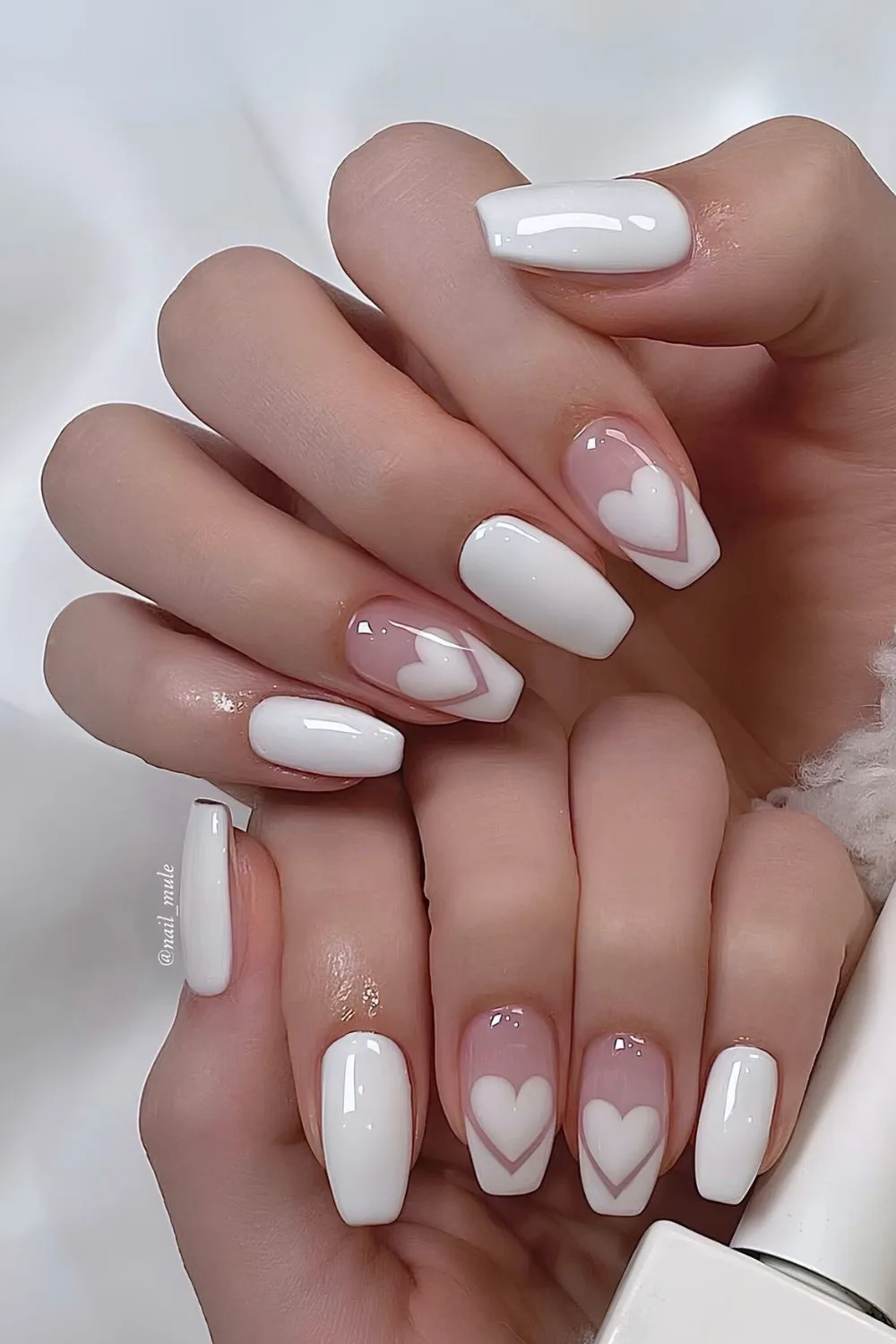 White mani with hearts and pointed french tip accents