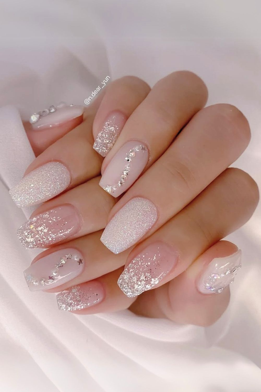 White nails with glitter and gems