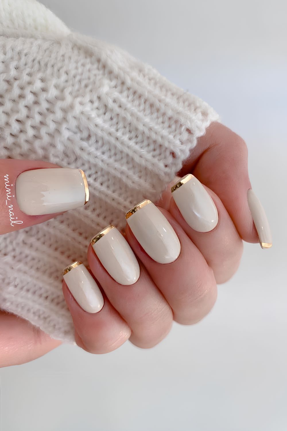 White nails with thin gold French tips