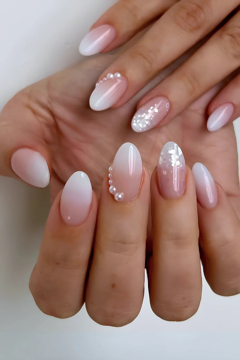 White ombre nails with pearls and glitter