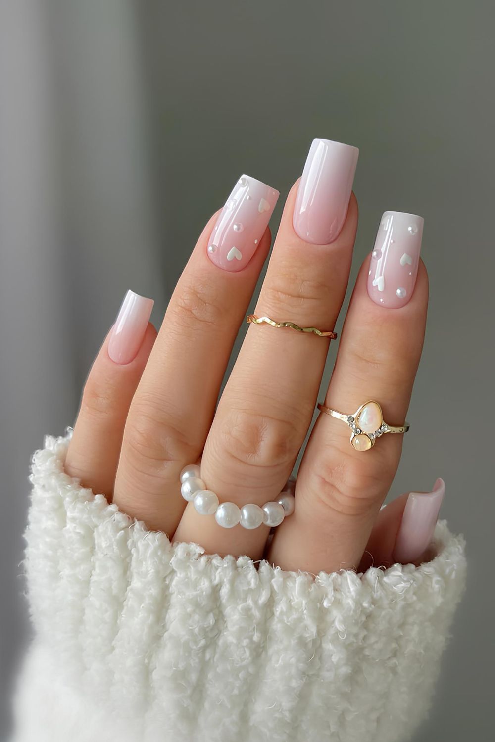 White ombre nails with pearls and hearts