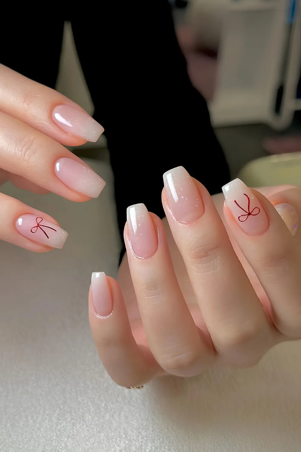 White ombre nails with red bows