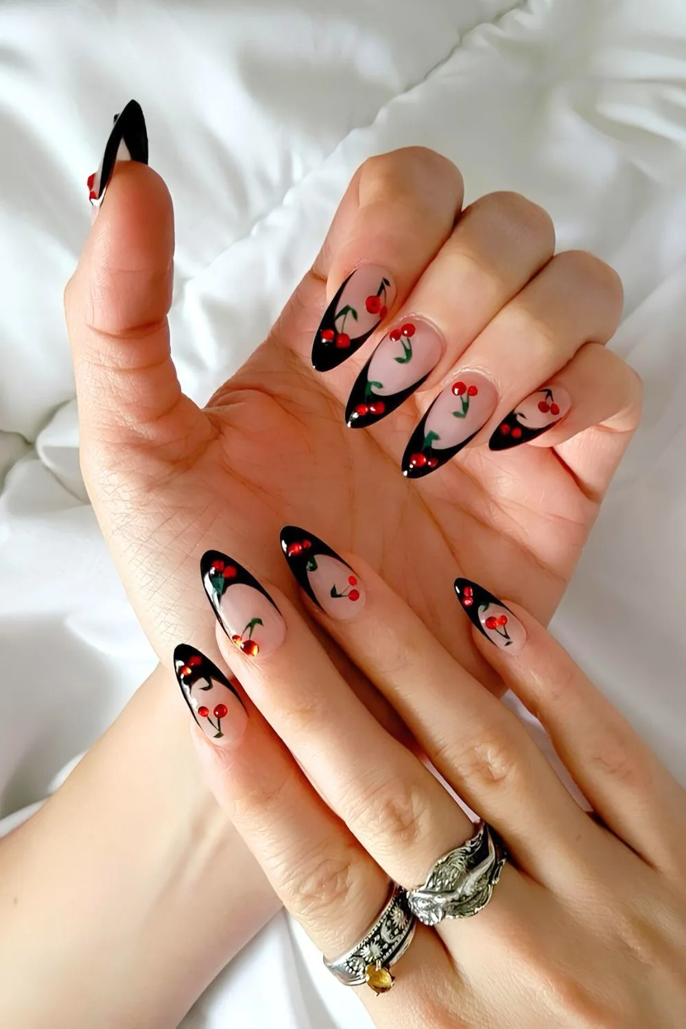 Black French nails with cherry accents