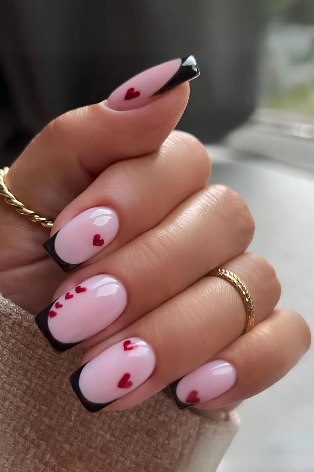 Black French nails with tiny red hearts