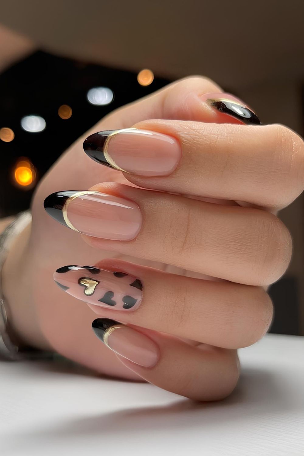 Black French tips with gold outlines and hearts