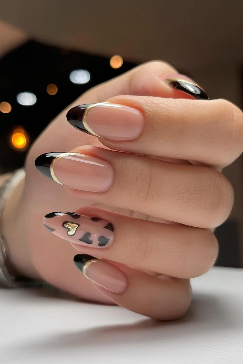 Black French tips with gold outlines and hearts