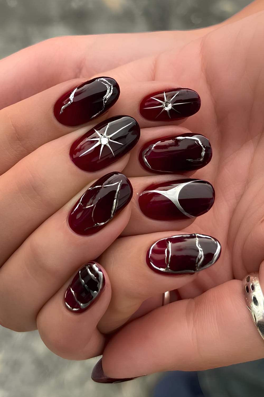 Black and red nails with silver chrome accents