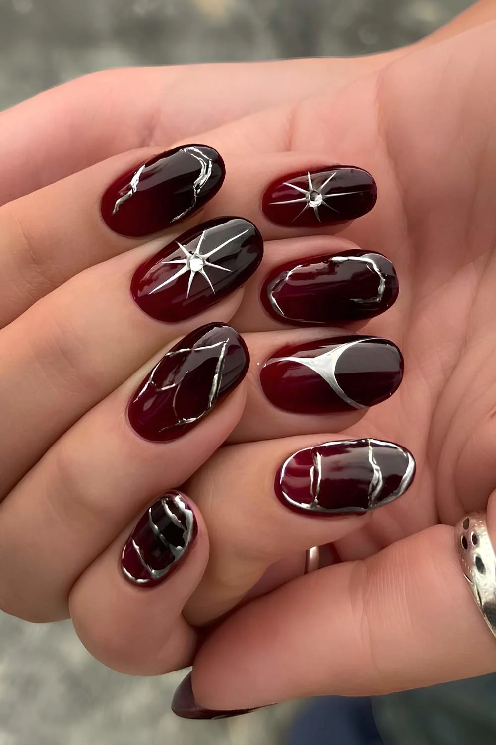 Black and red nails with silver chrome accents