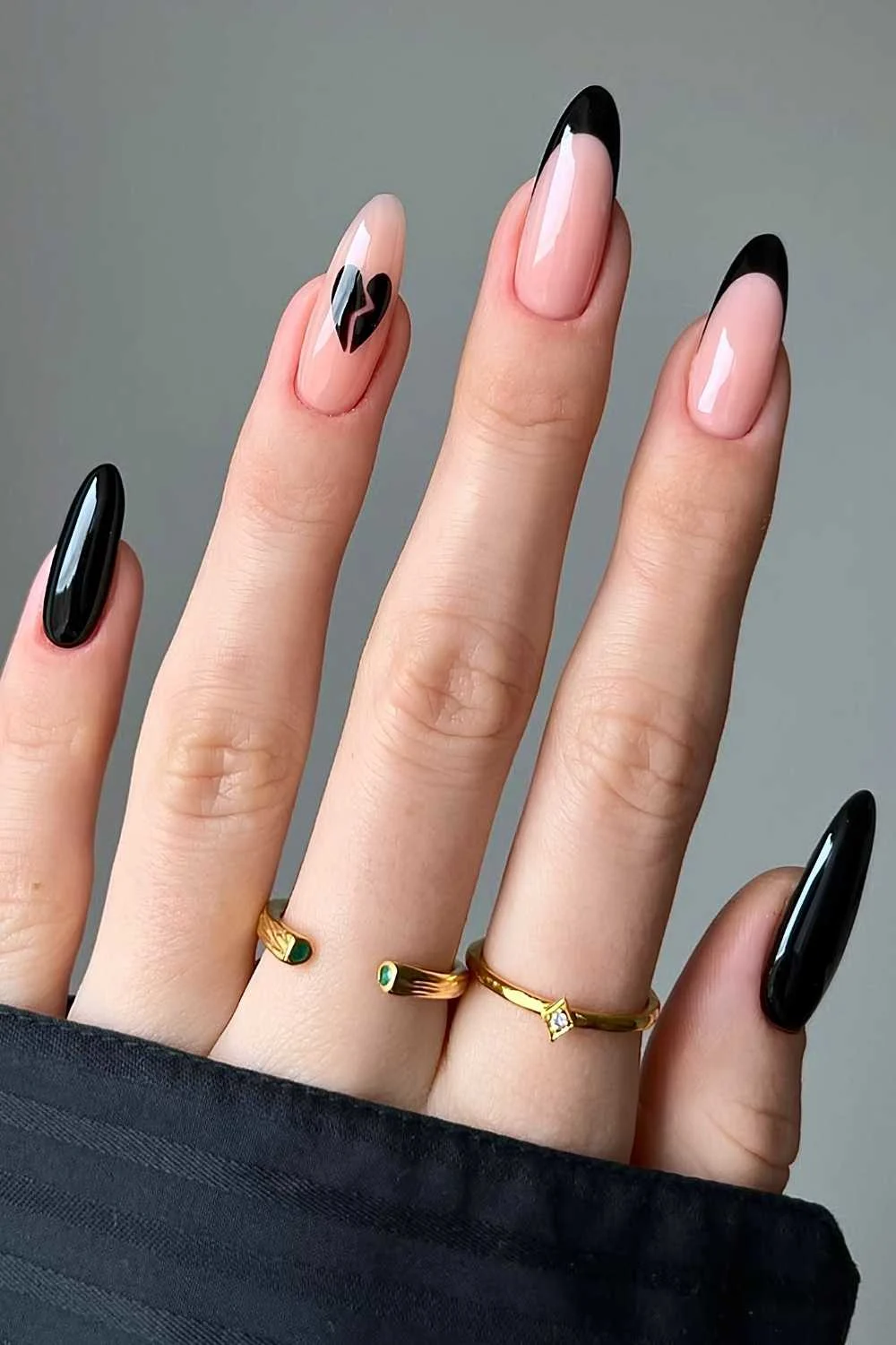 Black manicure with broken heart art