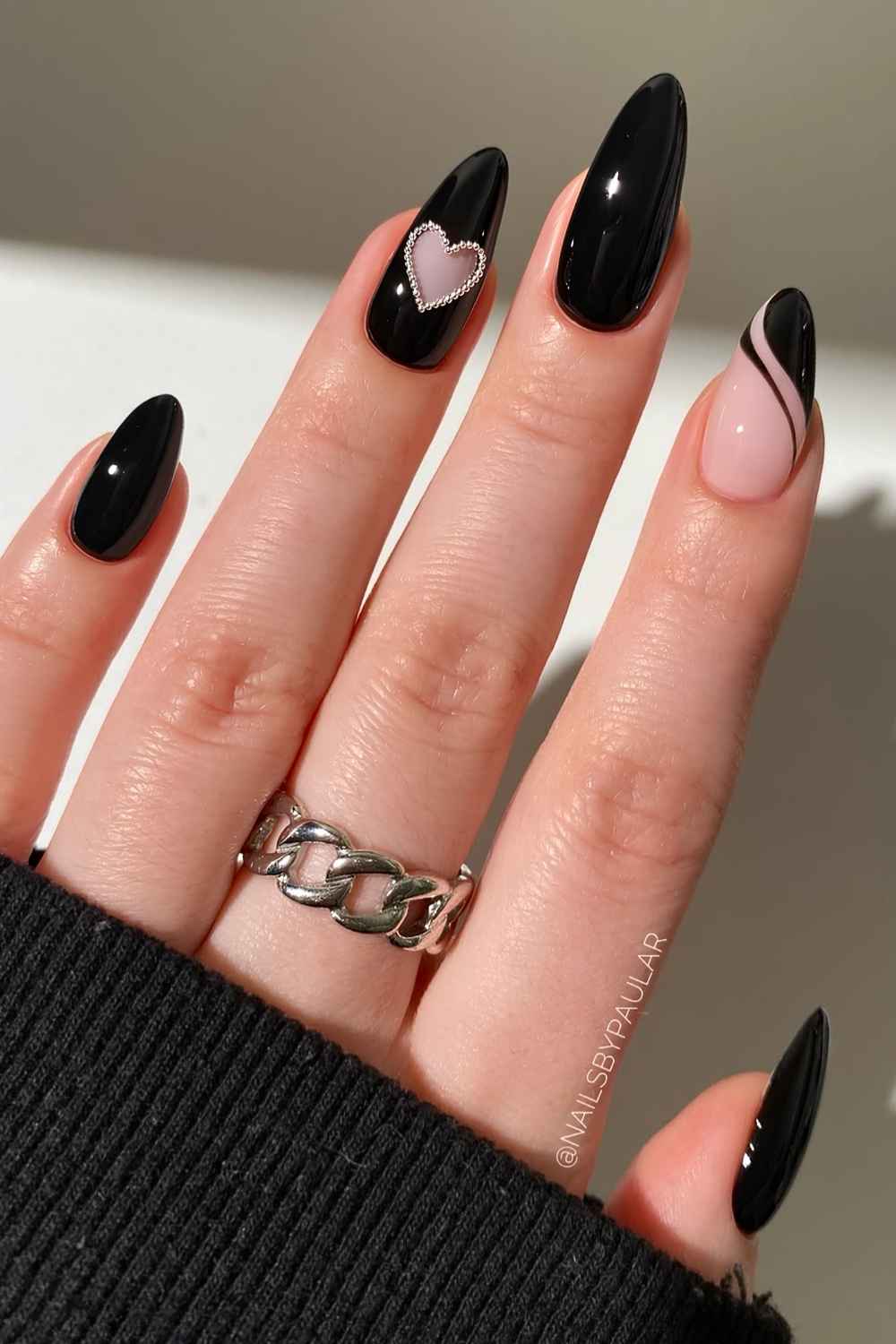 Black manicure with negative space heart accent