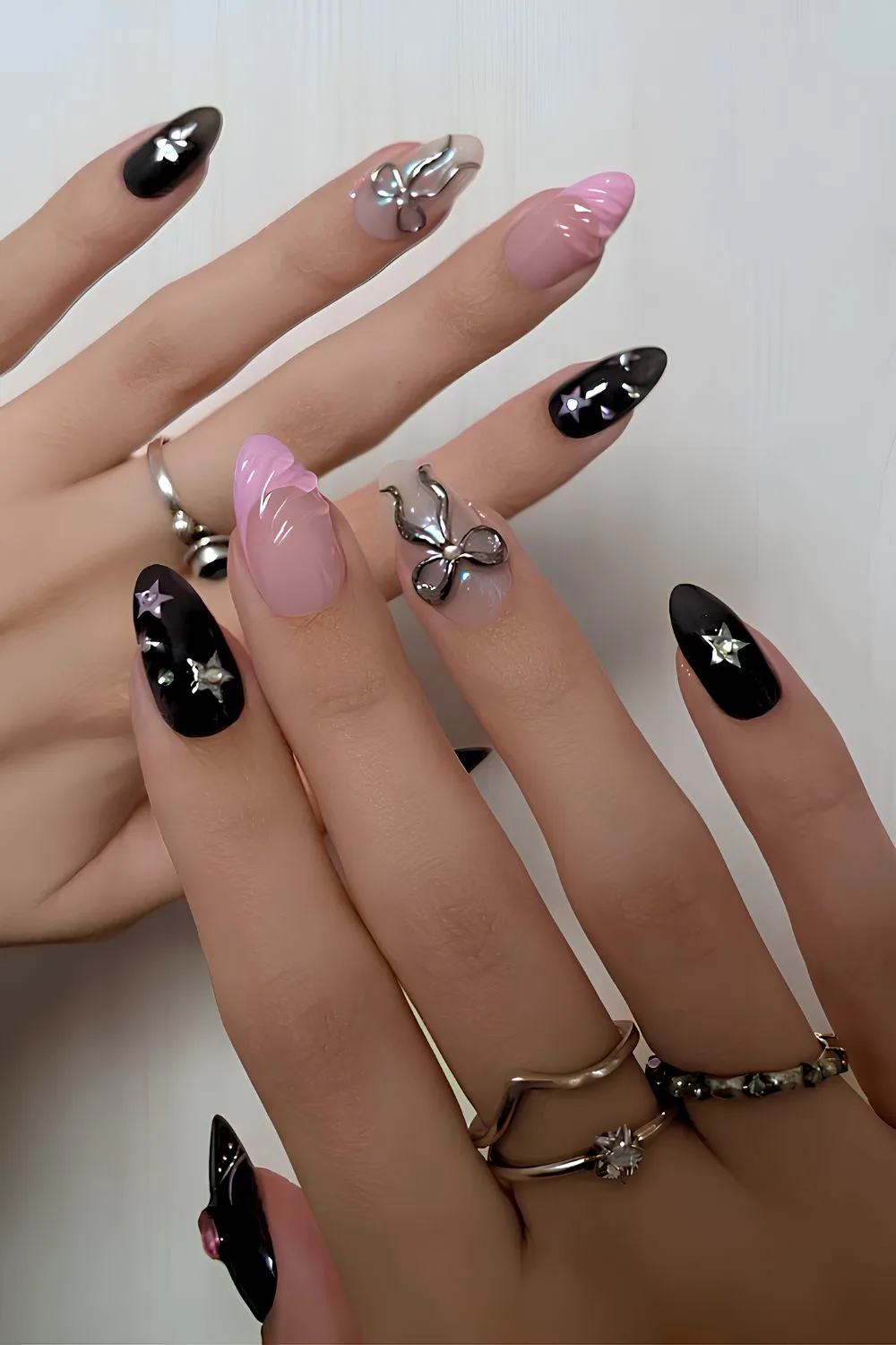 Black nails with pink and silver accents