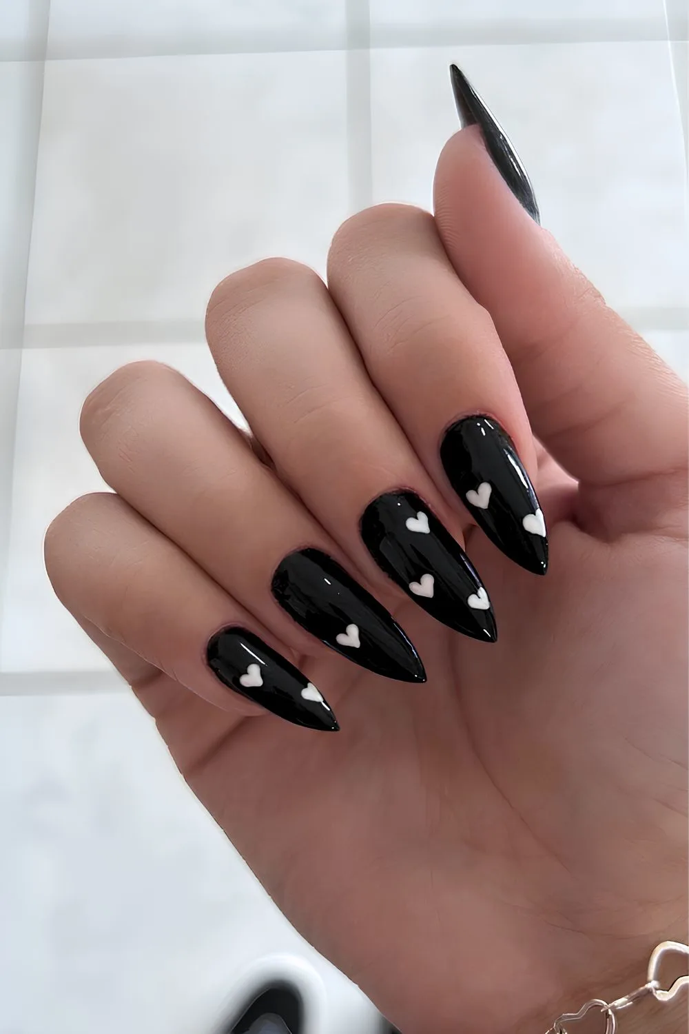 Black nails with tiny white hearts