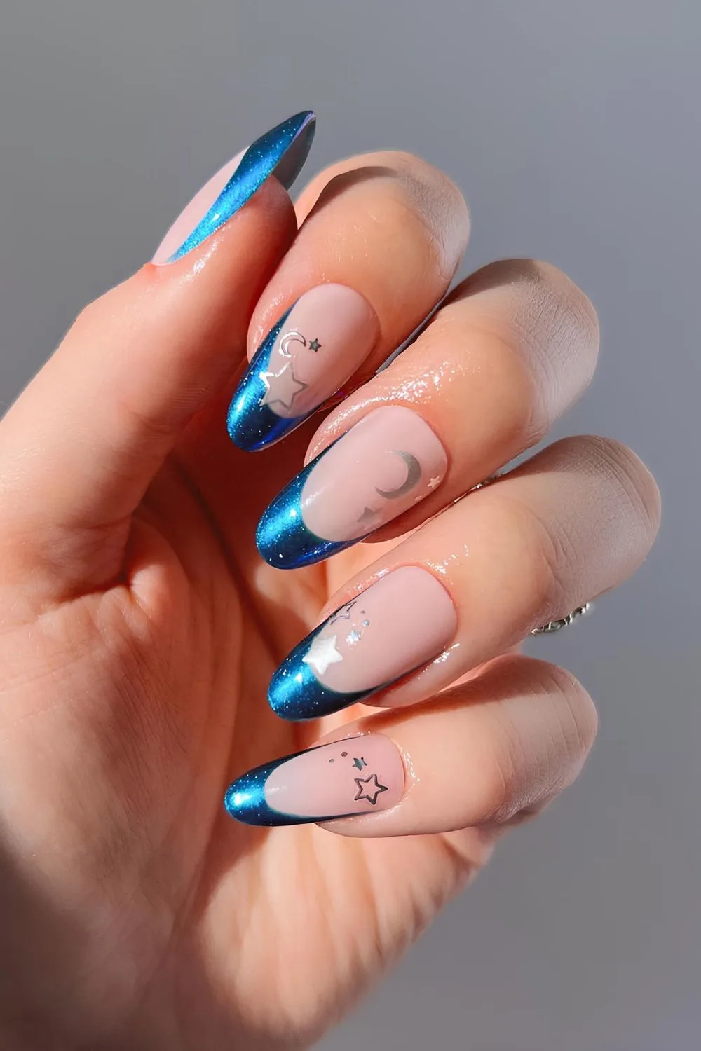 Blue chrome French nails with stars and moons