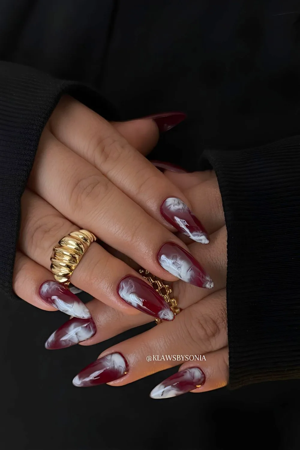 Burgundy marble nails with white swirly design