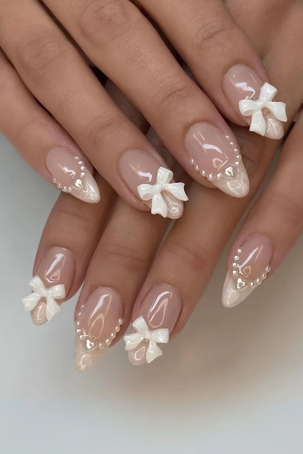 French mani with pearls and 3D bows