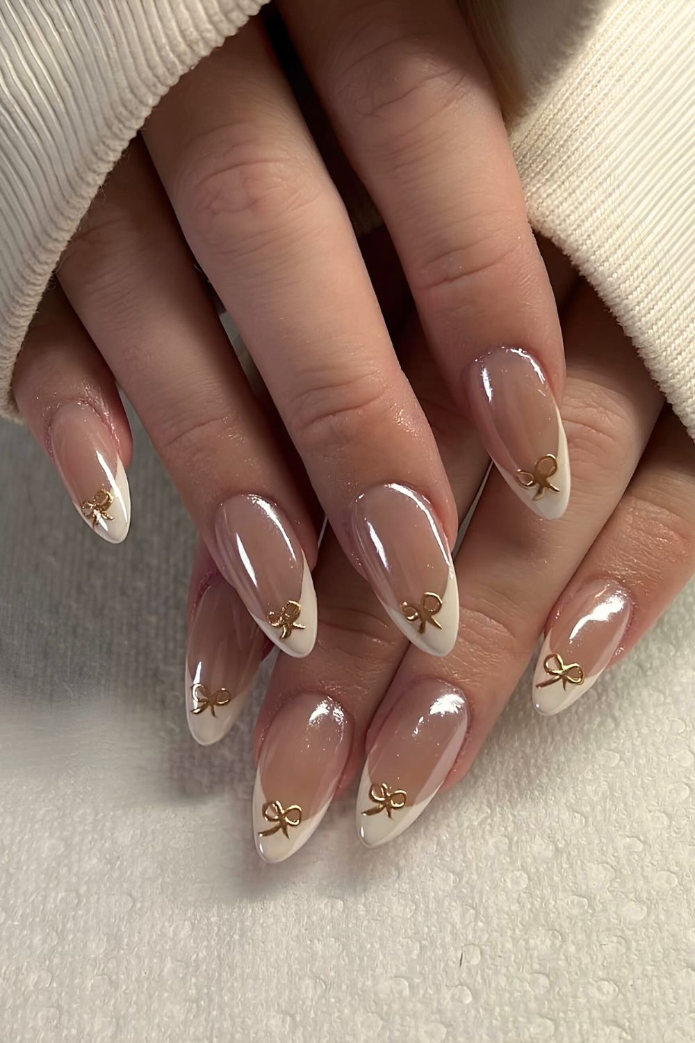 Glazed white French tip nails with gold bows