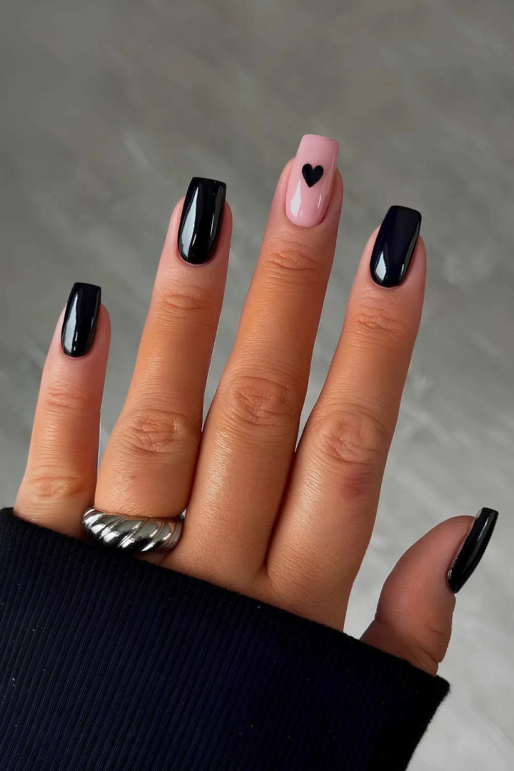 Glossy black manicure with heart accent