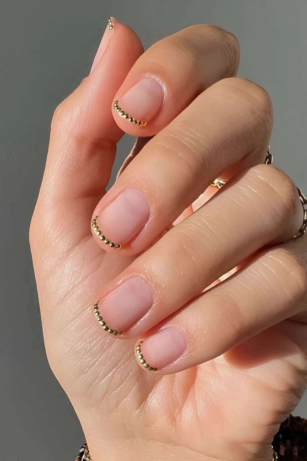 Gold chrome dotted French tip nails