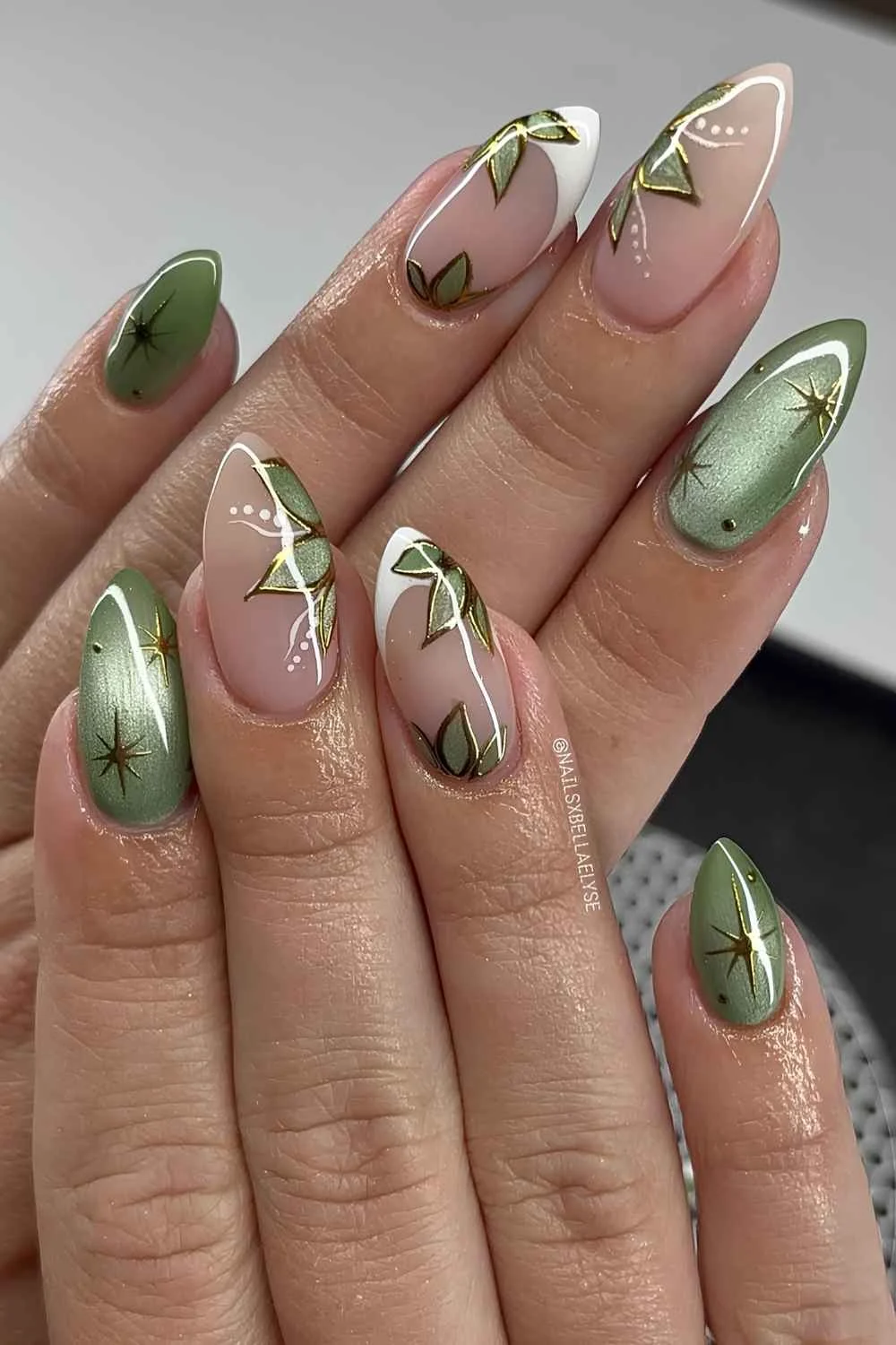 Green cat eye nails with florals and stars