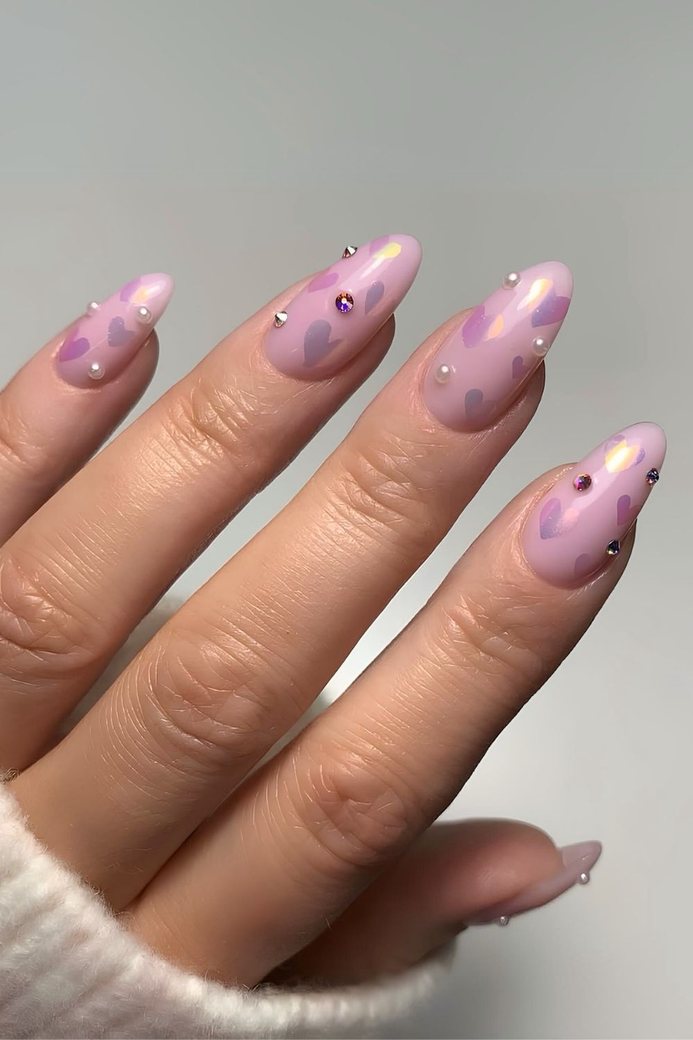 Light purple nails with heart, rhinestone and pearl accents