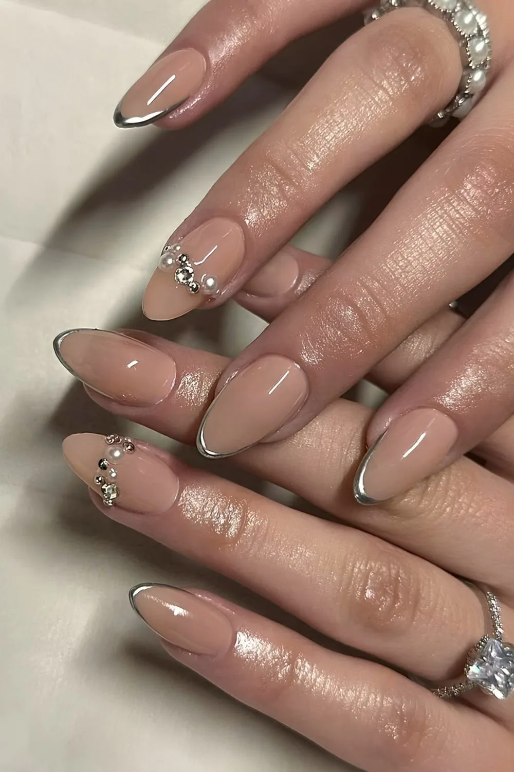 Micro silver chrome French tip nails with 3d pearl accents