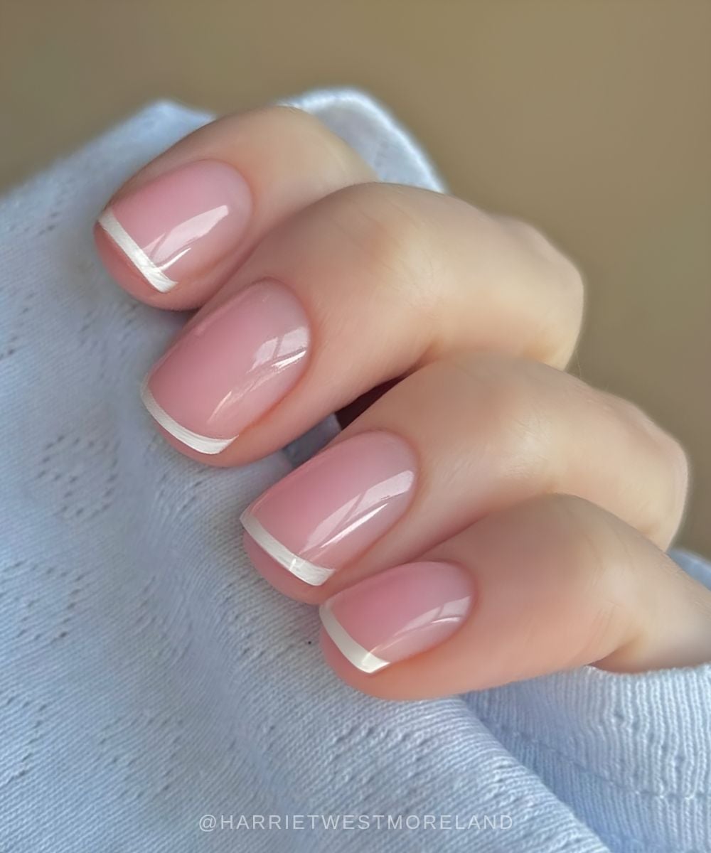 Micro white French nails on glowy pink base