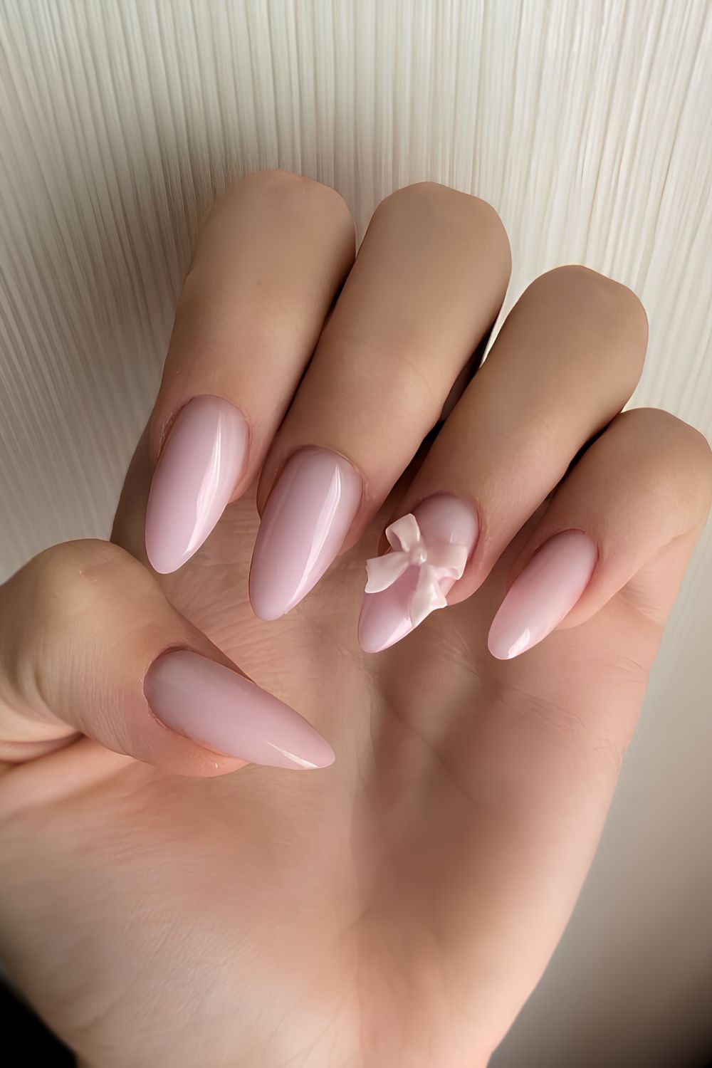 Milky pink manicure with 3D bows