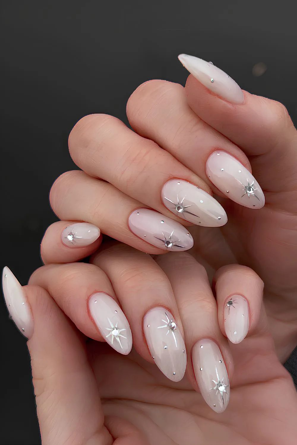 Milky white nails with celestial charms