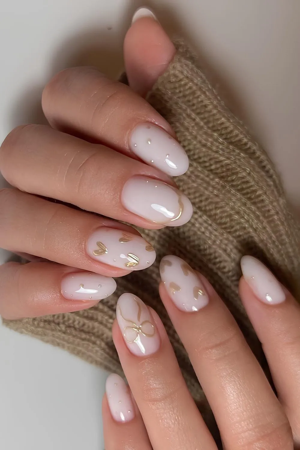 Milky white nails with chrome bows and hearts