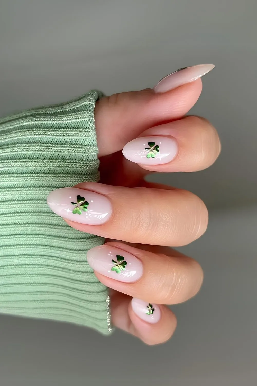 Milky white nails with green chrome shamrock art