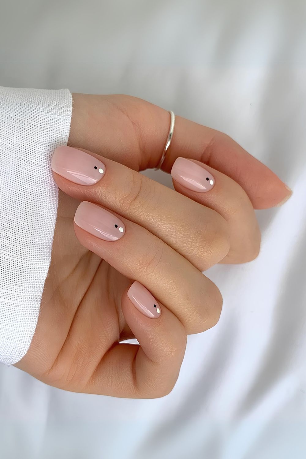 Neutral nails with black and white dot accents