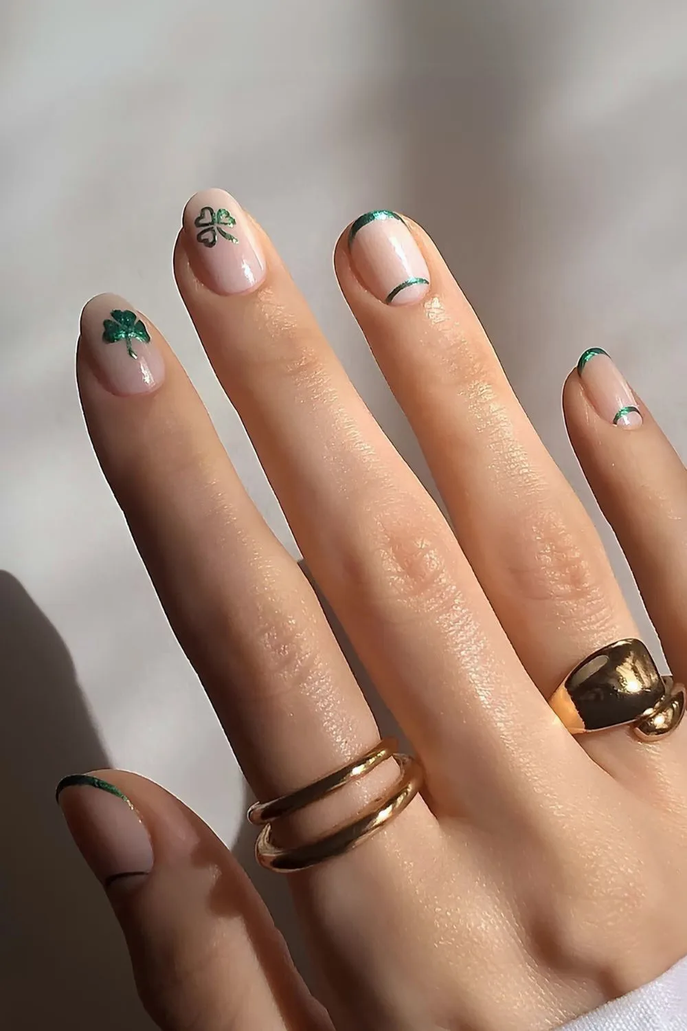 Neutral nails with chrome shamrock art