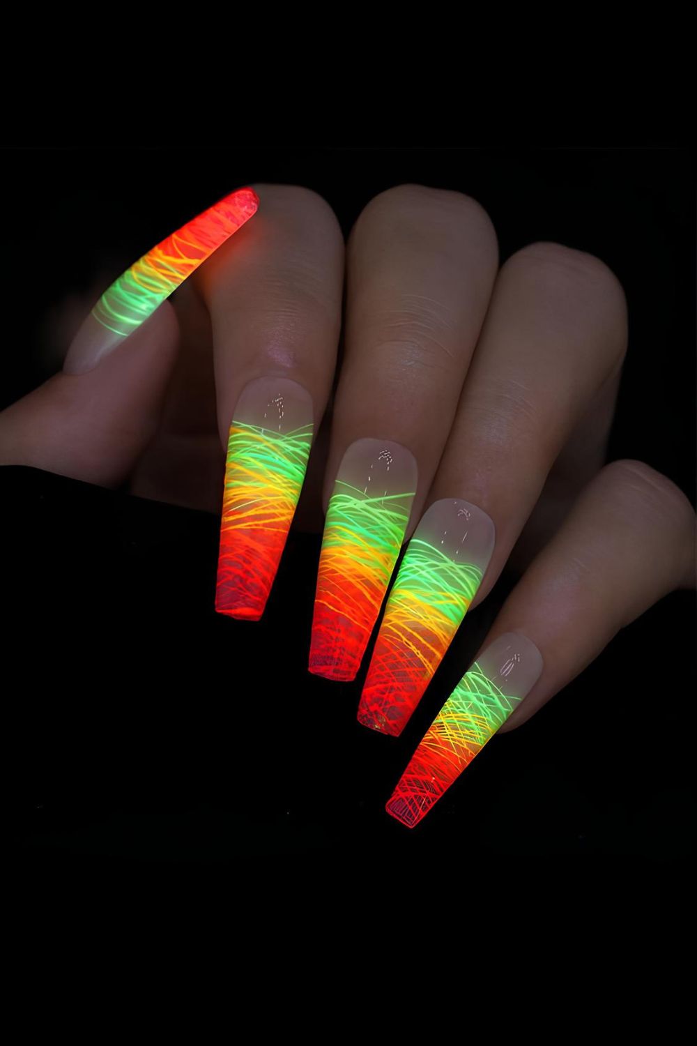 Orange and green glow-in-the-dark nails