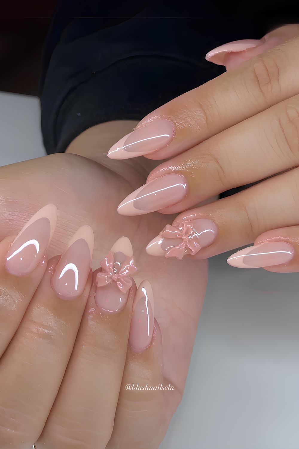 Peach French tip nails with 3D bows