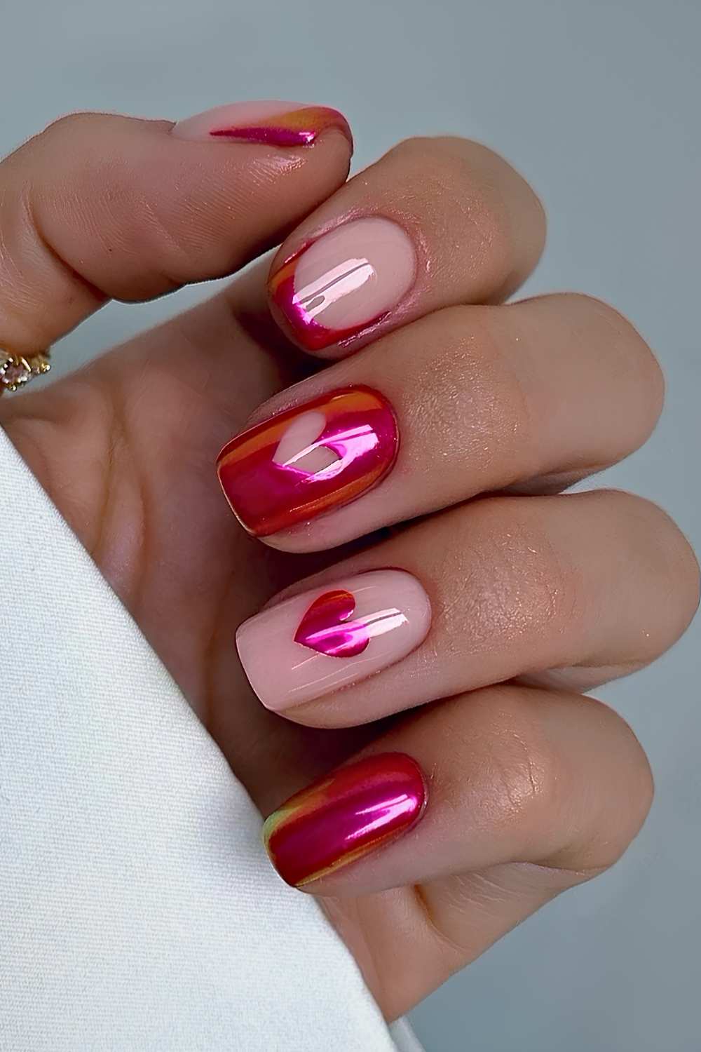 Pink and red dual chrome nails with hearts