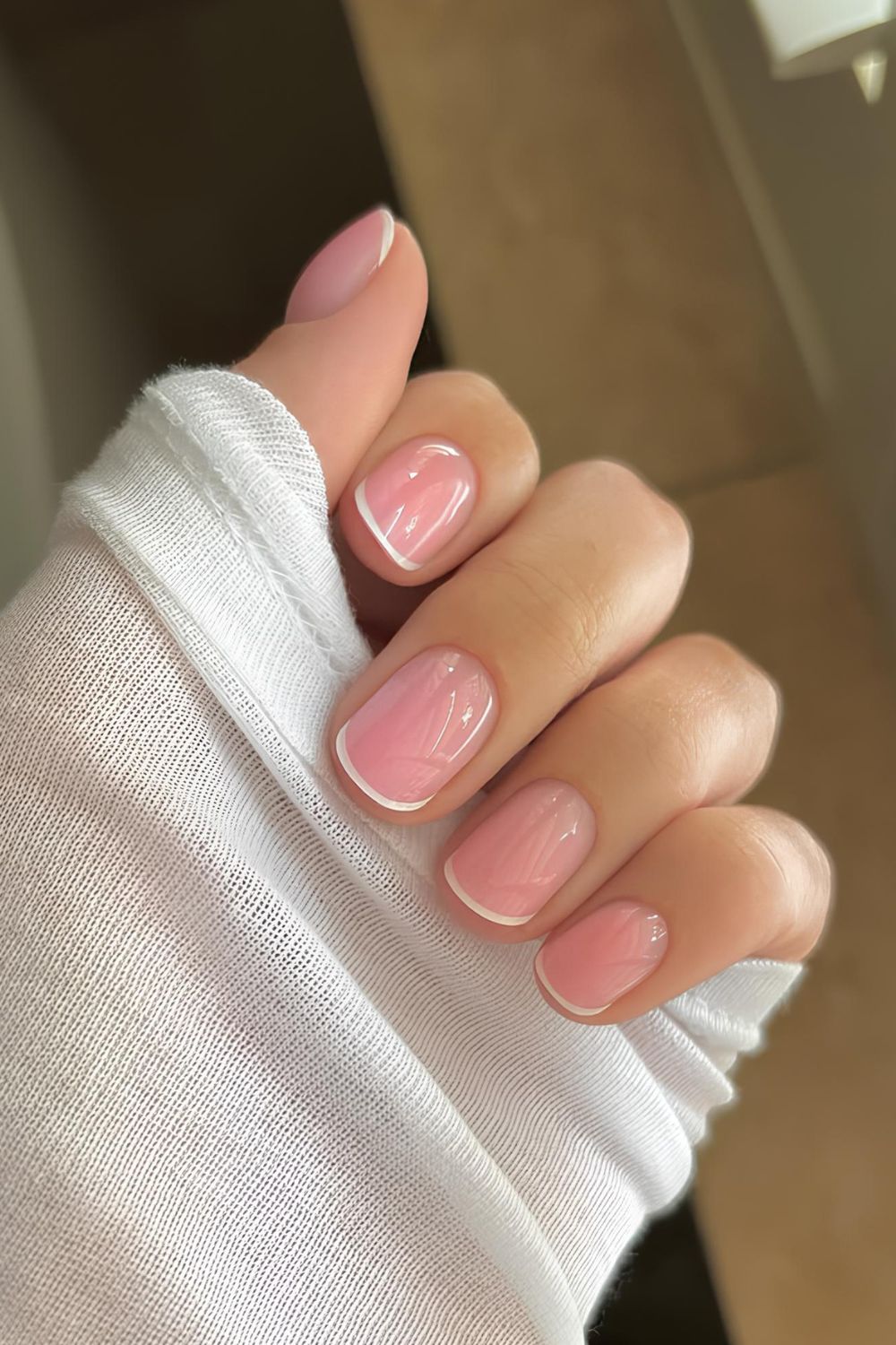 Pink-based glow micro French tip nails