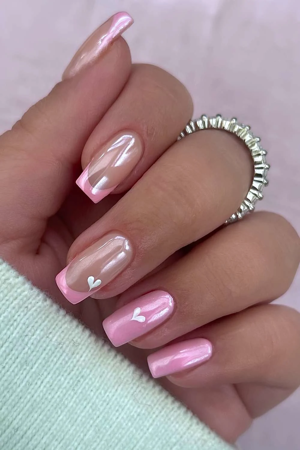 Pink chrome nails with hearts and accent French tips