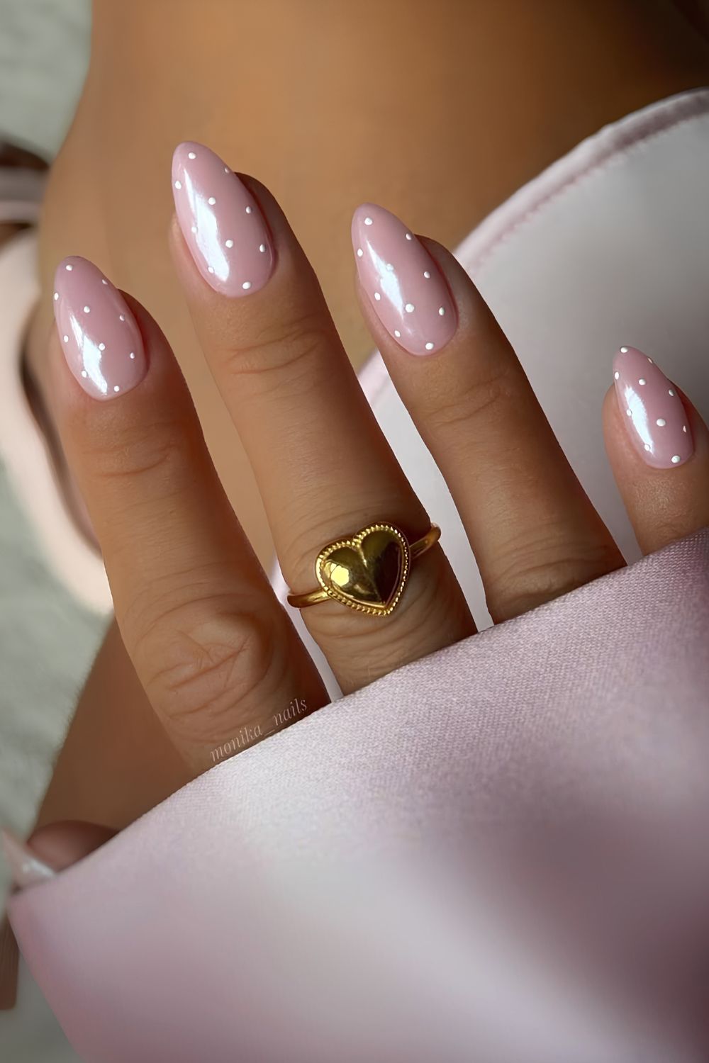 Pink chrome nails with polka dot art