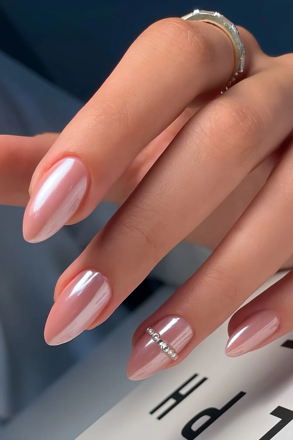 Pink chrome nails wth accent pearls