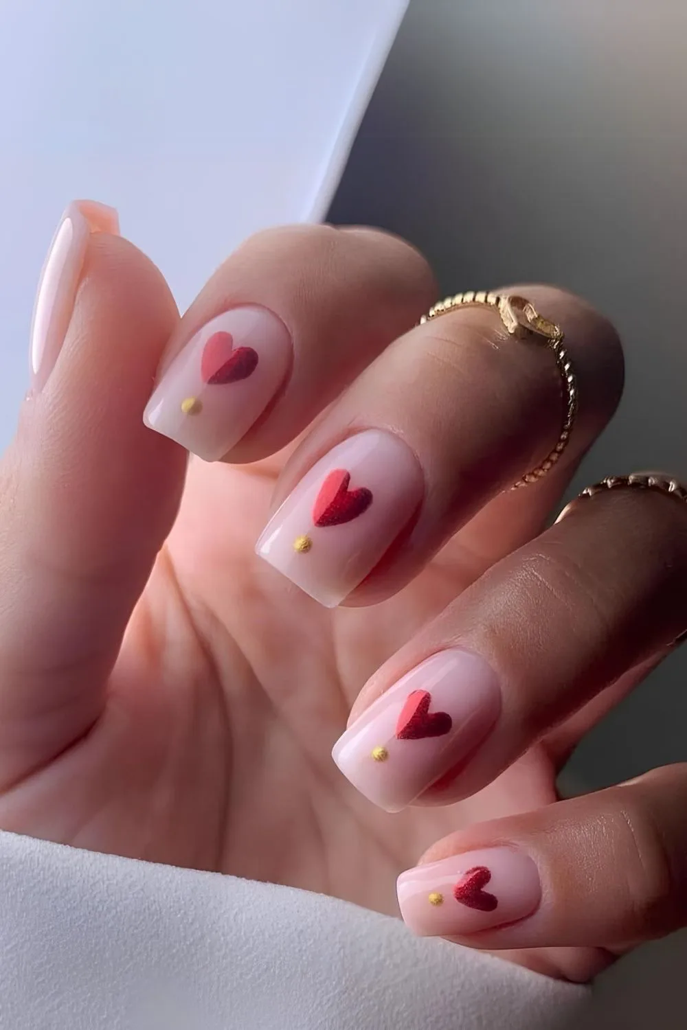 Pink mani with chunky red chrome hearts